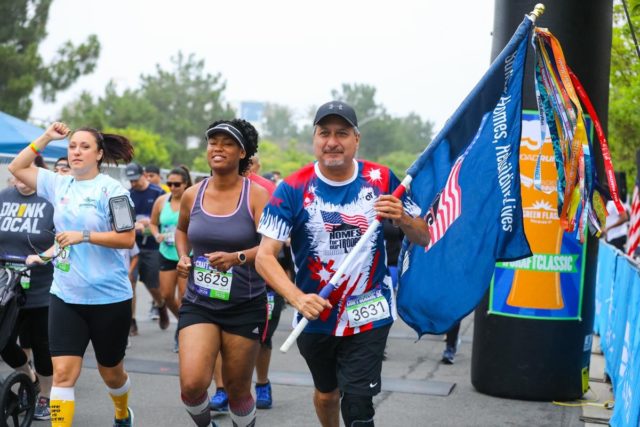 San Diego Running Co Craft Classic runner with a flag.