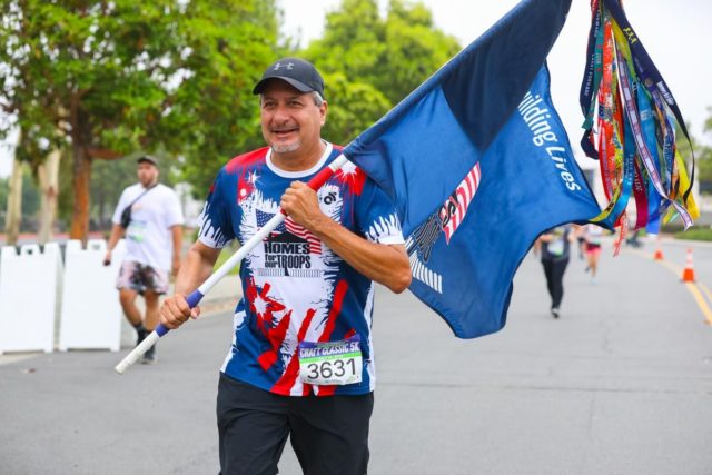 San Diego Running Co Craft Classic runner with a flag.